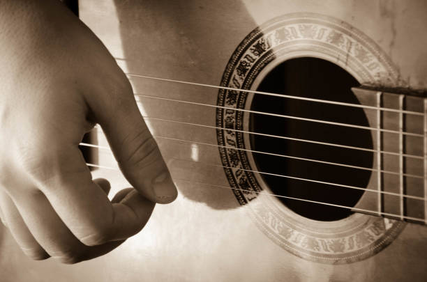 istock Man hands playing acoustic guitar, close up 675071992
