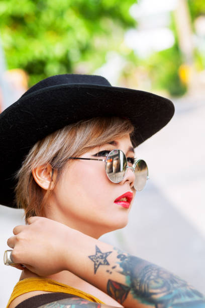 istock Thai girl with tattoos and black hat 675072226