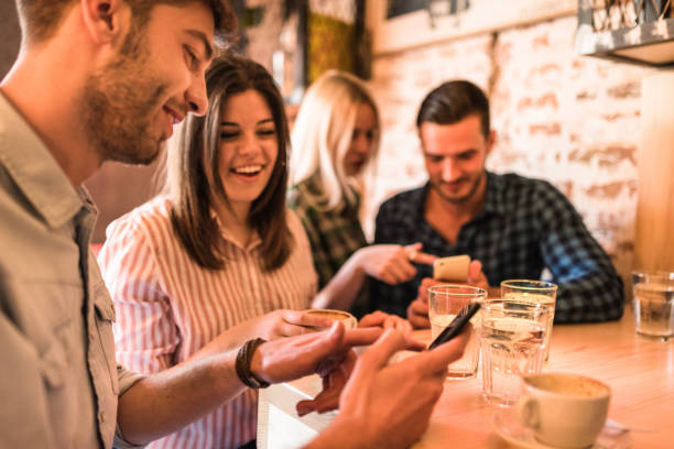 istock friends using take a cappuccino at the cafe 675072928