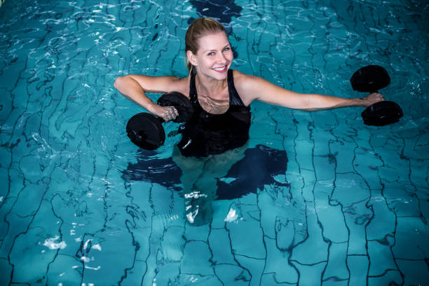 istock Fit smiling woman holding weights 675073142
