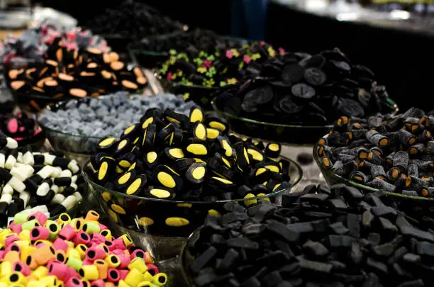 many varieties of liquorice sweets candies on a market stall