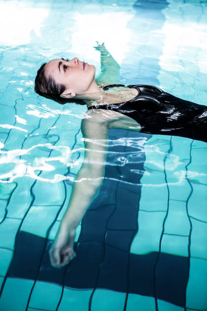 istock Relaxed woman floating in the swimming pool 675074674