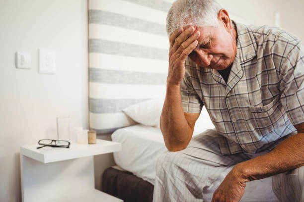 istock Frustrated senior man sitting on bed 675075754