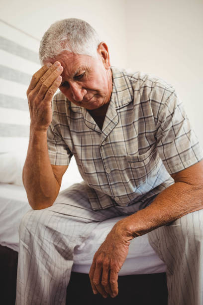 istock Frustrated senior man sitting on bed 675075964