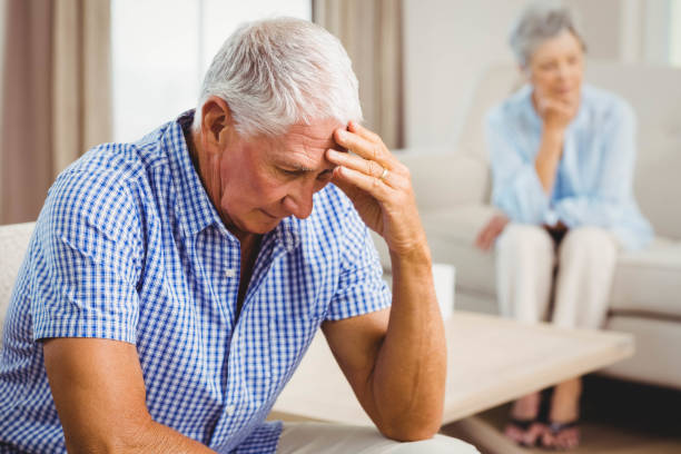 istock Worried senior man sitting on sofa 675076172
