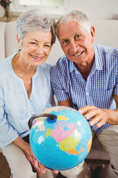 istock Senior couple holding a globe 675076814