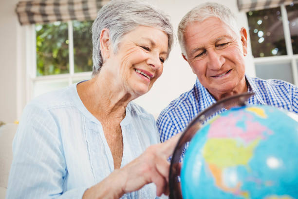 istock Senior couple looking at a globe 675076842