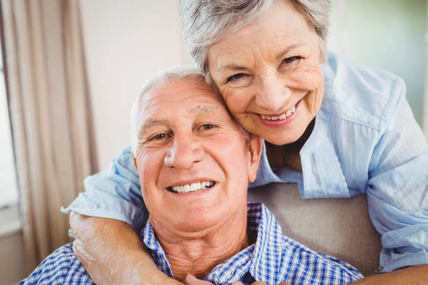 istock Senior woman embracing man at home 675077016