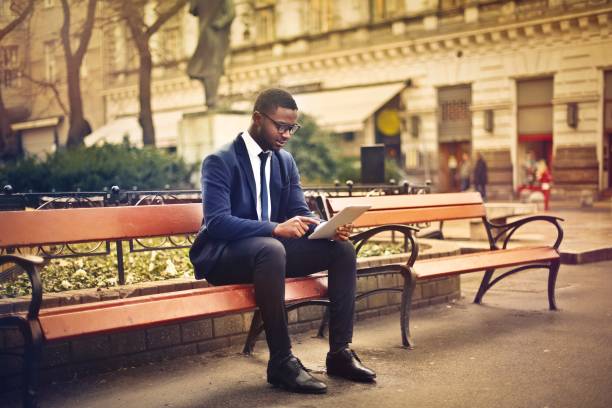 istock Businessman is reading on a bench 675077534