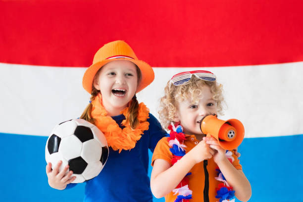 Kids supporting Netherlands football team Children cheering and supporting Dutch football team. Kids fans and supporters of the Netherlands during soccer championship. Boy and girl from Holland with national flag and country symbols. 11904 stock pictures, royalty-free photos & images