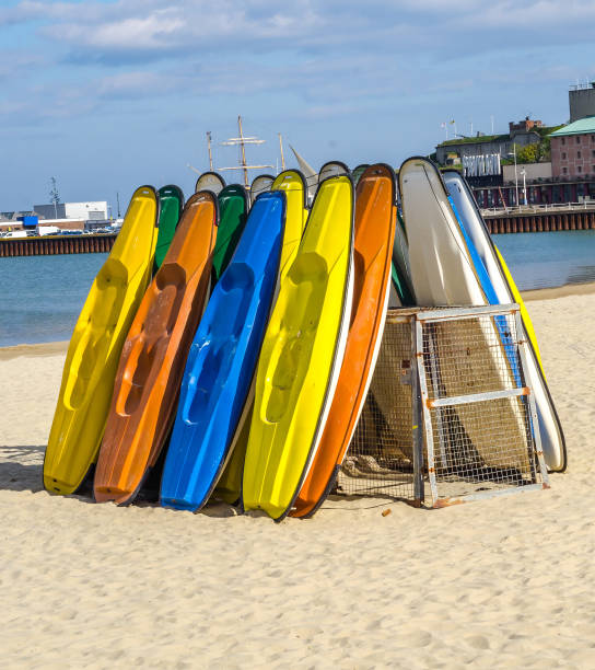 istock Sandy beach, color kayaks based on stand, in background beautiful view on blue ocean 675079176