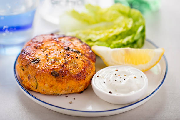 Salmon fishcake burger with mayo and lettuce Salmon fishcake burger with mayo and lettuce pepper cake stock pictures, royalty-free photos & images