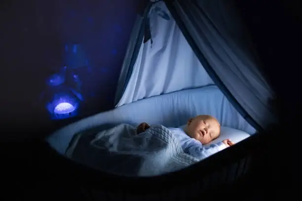 Photo of Baby boy drinking milk in bed