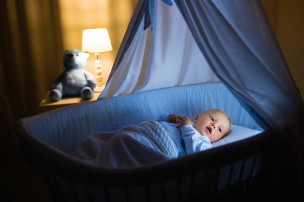 istock Baby boy drinking milk in bed 675079838