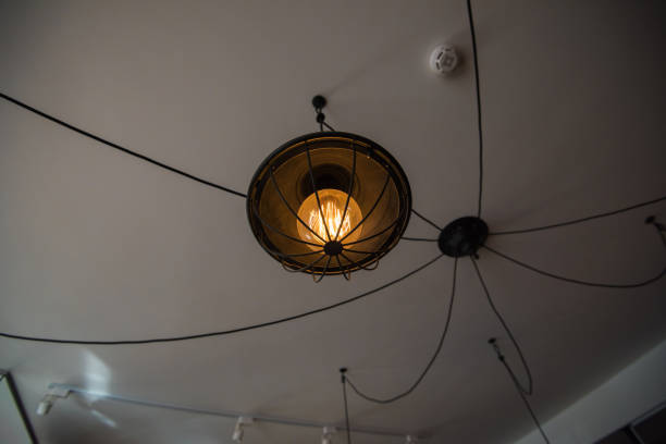 istock Decorative vintage style Edison type glowing light bulb in the luxury interior 675082312