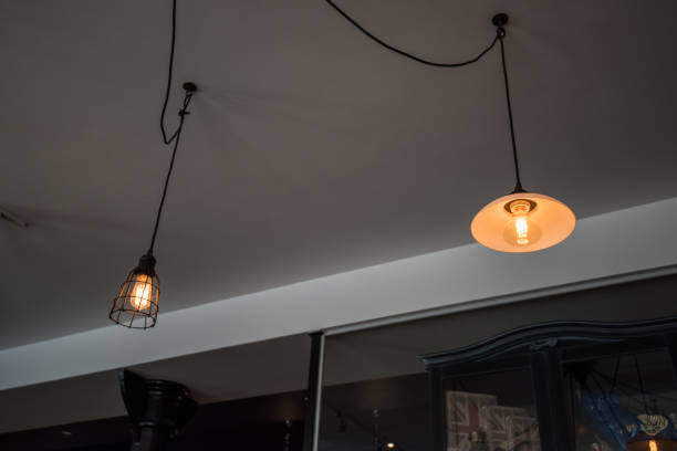 istock Decorative vintage style Edison type glowing light bulb in the modern interior 675082320