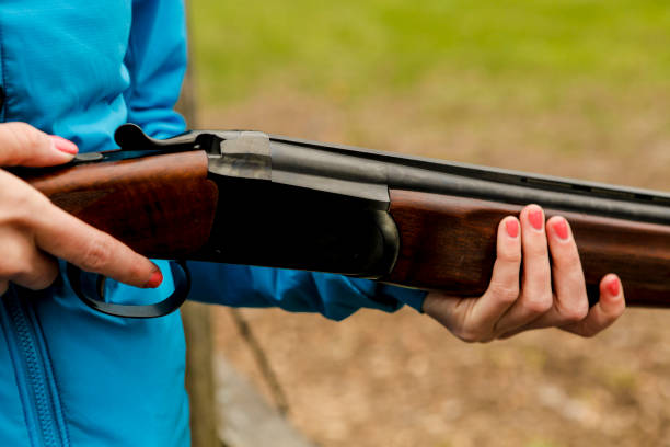 istock Young woman with shotgun. 675083124