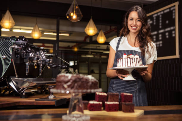 istock Smiling barista holding plate with cake 675089498