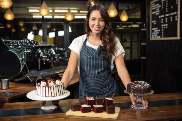 istock Smiling barista presenting plate with cakes 675089760
