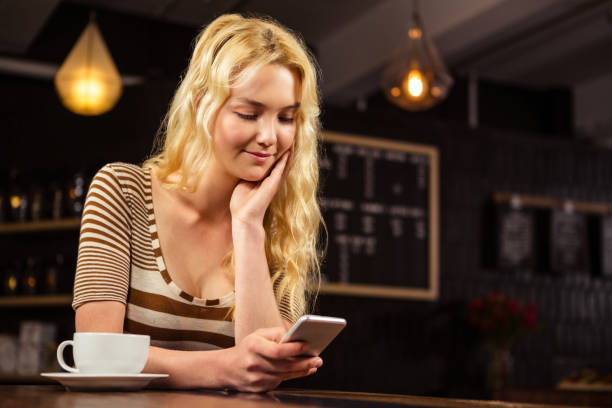 istock Woman drinking coffee and using smartphone 675090022