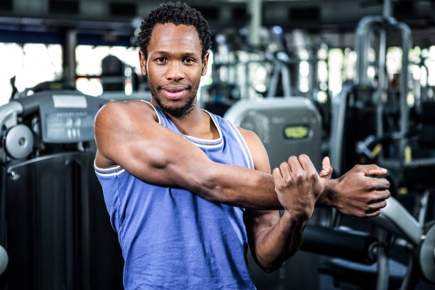 istock Smiling muscular man stretching arms 675090326