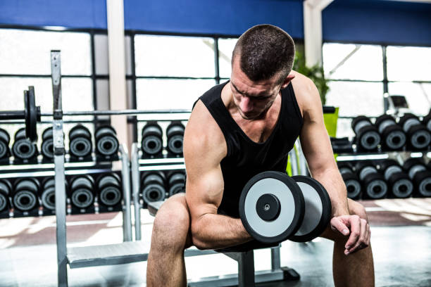istock Muscular man exercising with dumbbells 675091302