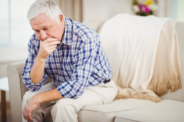 istock Worried senior man sitting on sofa 675091562