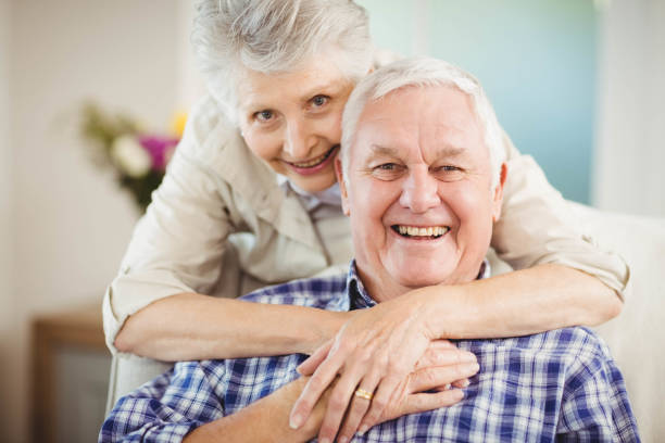 istock Senior woman embracing man at home 675091574