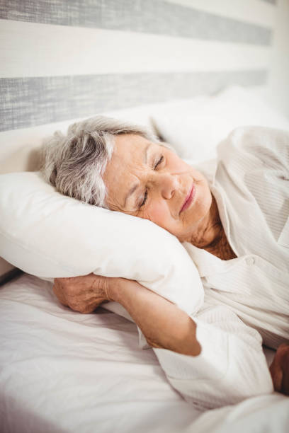 istock Senior woman sleeping on bed 675091748