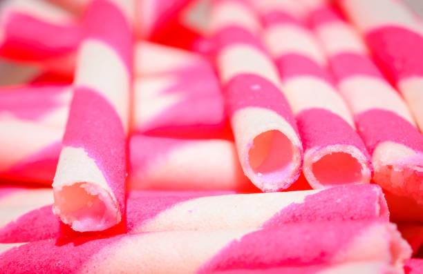 wafer rolls wafer rolls filled with strawberry stick pattern ice cream with wafer rolls stock pictures, royalty-free photos & images