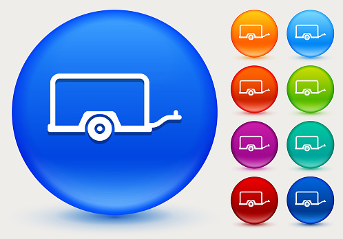 Moving Carriage Icon on Shiny Color Circle Buttons. The icon is positioned on a large blue round button. The button is shiny and has a slight glow and shadow. There are 8 alternate color smaller buttons on the right side of the image. These buttons feature the same vector icon as the large button. The colors include orange, red, purple, maroon, green, and indigo variations.