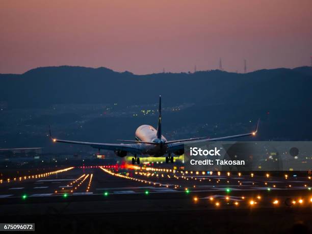 Landing On Osaka International Airport Stock Photo - Download Image Now - Airfield, Airport Runway, Illuminated