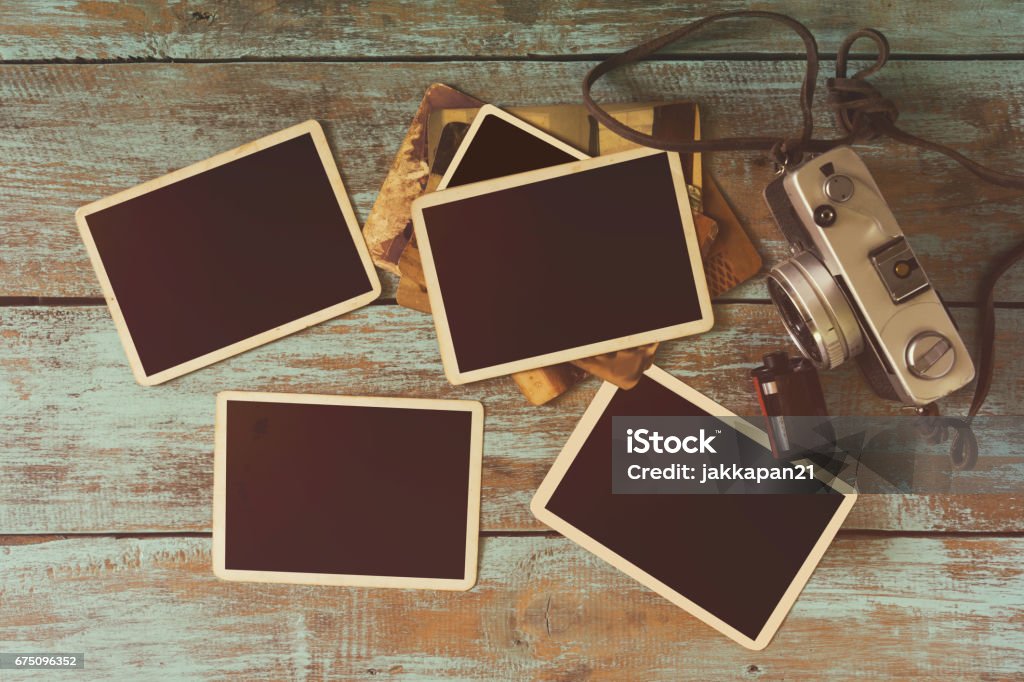 vintage photo frame Retro camera and empty old instant paper photo album on wood table - blank photo frame vintage style Photographic Print Stock Photo