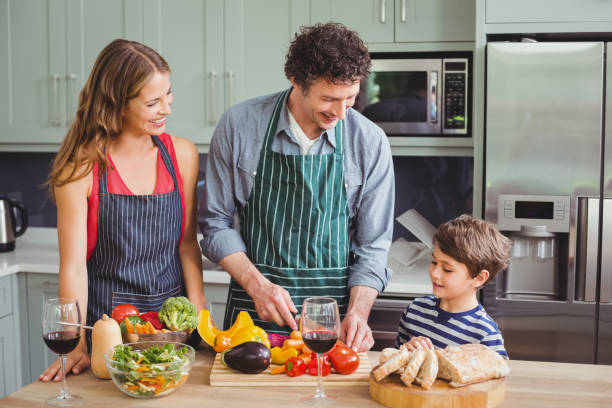 istock Smiling parents with son in kitchen 675120008