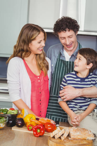 istock Happy parents with son in kitchen 675120238