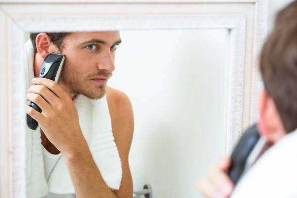 istock Young man shaving with trimmer 675171566