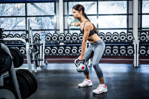 istock Serious fit woman lifting kettlebell 675177000