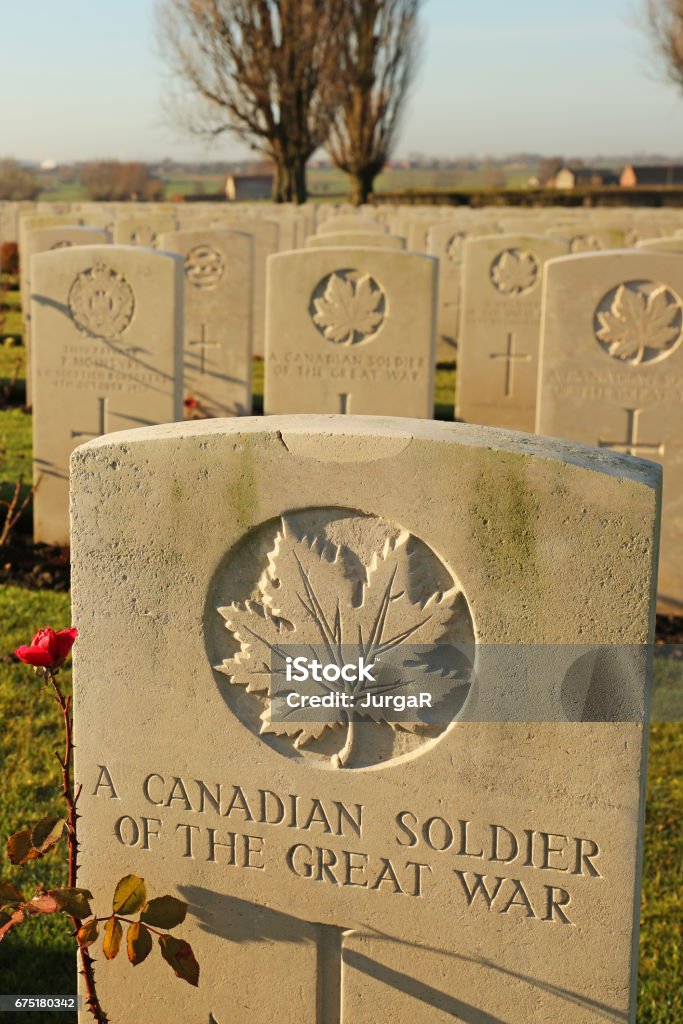 Tyne Cot Cemetery Grave to an Unknown Canadian Soldier A grave to an unknown Canadian soldier of The Great War at Tyne Cot Cemetery near Ypres in Belgium. Agricultural Field Stock Photo