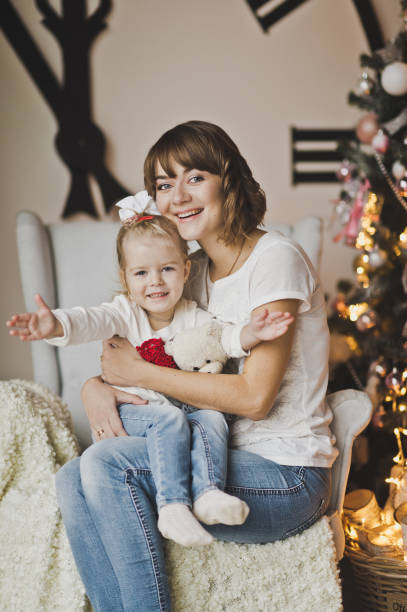 istock Young mother with daughter on hands on the huge clock 7263. 675183358