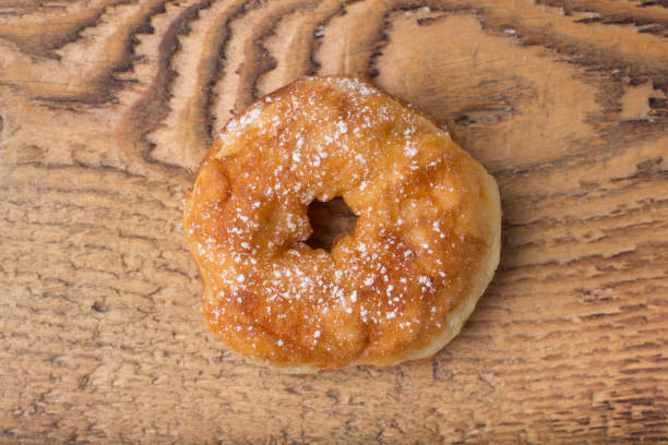 istock sugary donut on a wooden background 675195380