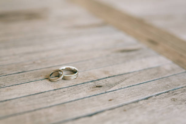 istock Wedding rings on a light wooden texture 675196386