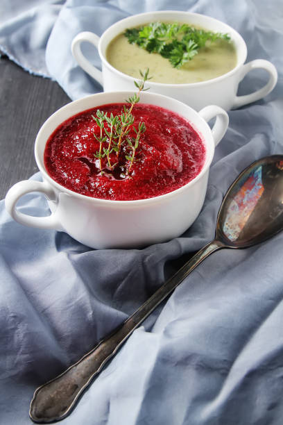 Traditional beetroot soup in white plate with Temyan, sour cream. Dark wooden background. free space text.