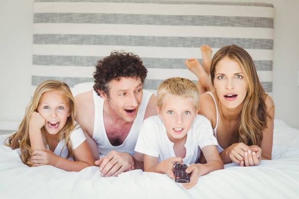 istock Family relaxing on bed at home 675200558