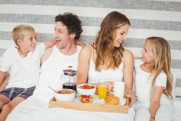 istock Happy family enjoying breakfast on bed 675203060
