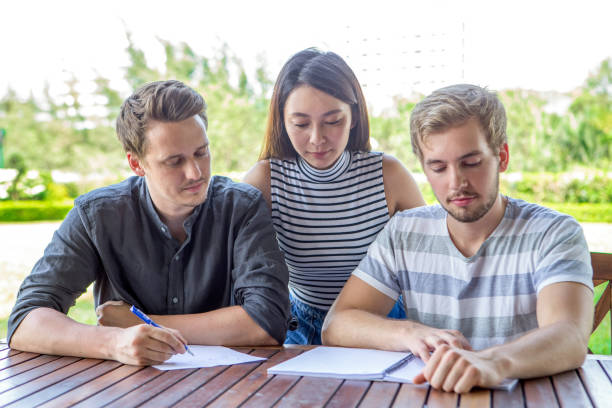istock Serious student friends doing homework together 675203244