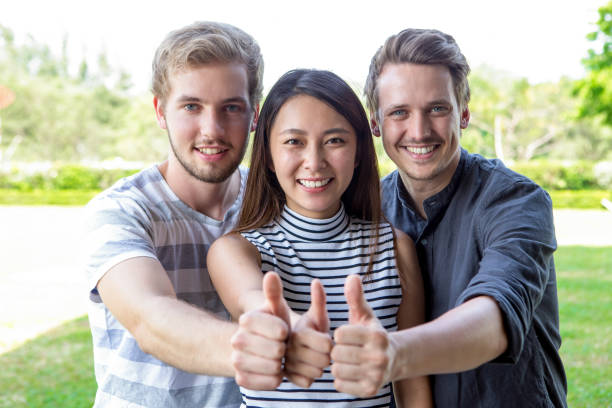 istock Three successful student friends showing thumbs up 675203284