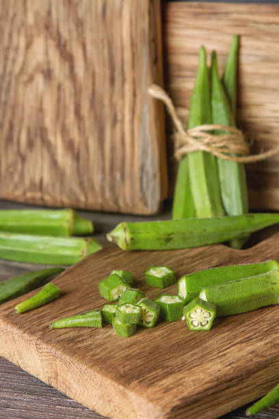 istock Lady Fingers or Okra over wooden table background. 675203562