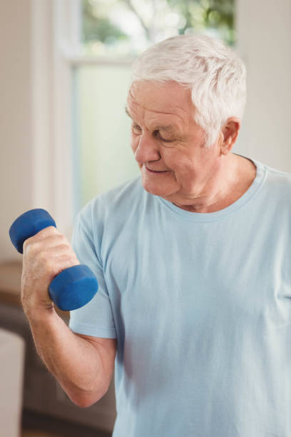 istock Senior man exercising with dumbbells 675203622