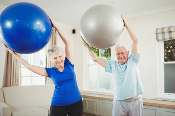 istock Senior couple exercising with exercise ball 675206028