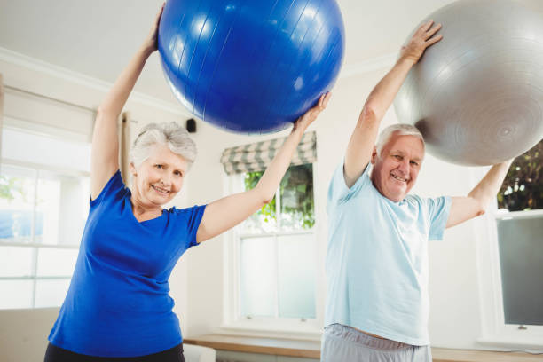 istock Senior couple exercising with exercise ball 675206048